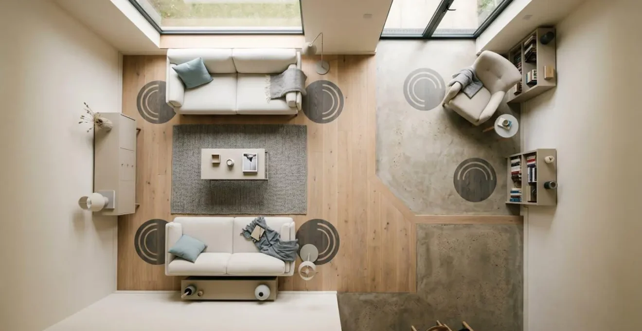 Overhead view showing strategic speaker placement zones in an L-shaped living room layout