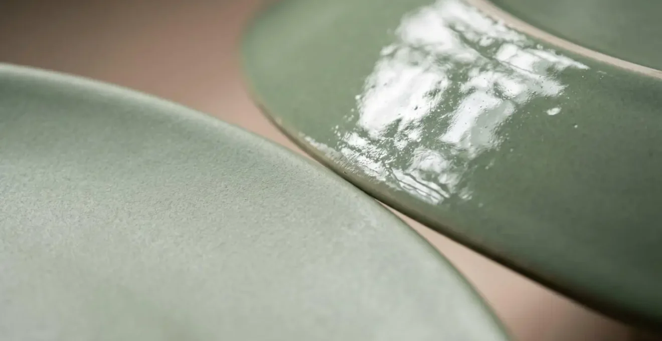 Macro close-up showing textural detail and light diffusion on matte ceramic surface versus glossy glaze