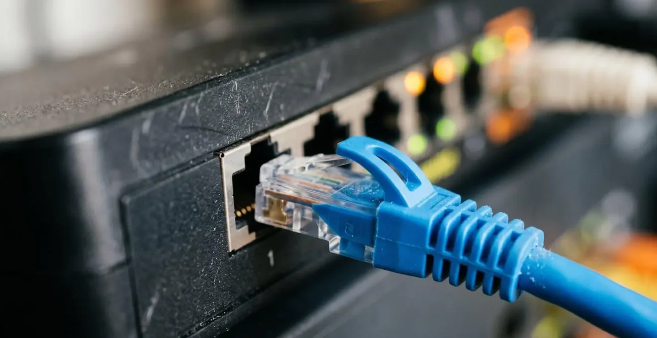 Macro detail of ethernet cable connection to broadband router showing network infrastructure